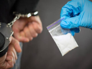 A police officer finds drugs during the search of drug dealers